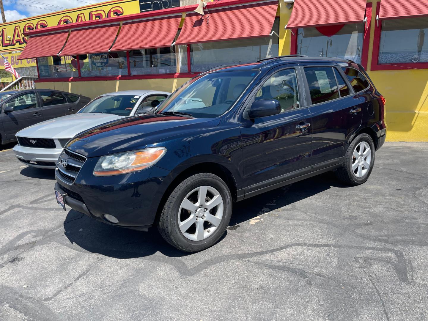 2009 Royal Blue Pearl /Tan Hyundai Santa Fe Limited (5NMSH13EX9H) with an 3.3L V6 engine, Automatic transmission, located at 801 South State Street, Salt Lake City, UT, 84111, (801) 328-0098, 40.751953, -111.888206 - Features Top Features: Alloy Wheels, Rear Entertainment System, Front Seat Heaters, Satellite Radio Ready, Infinity Sound System, Sunroof(s), Leather Seats, Third Row Seat Basic Features: ABS Brakes, Auxiliary Audio Input, Overhead Airbags, Power Windows, AM/FM Stereo, CD Audio, Power Locks, Rear - Photo#0